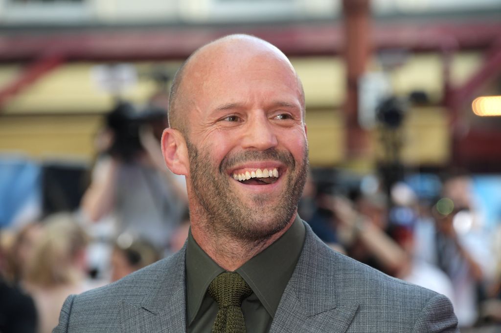 Jason Statham smiling in his suit