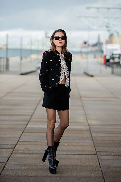 Woman wears cute outfit of heart studded jacket and mini skirt