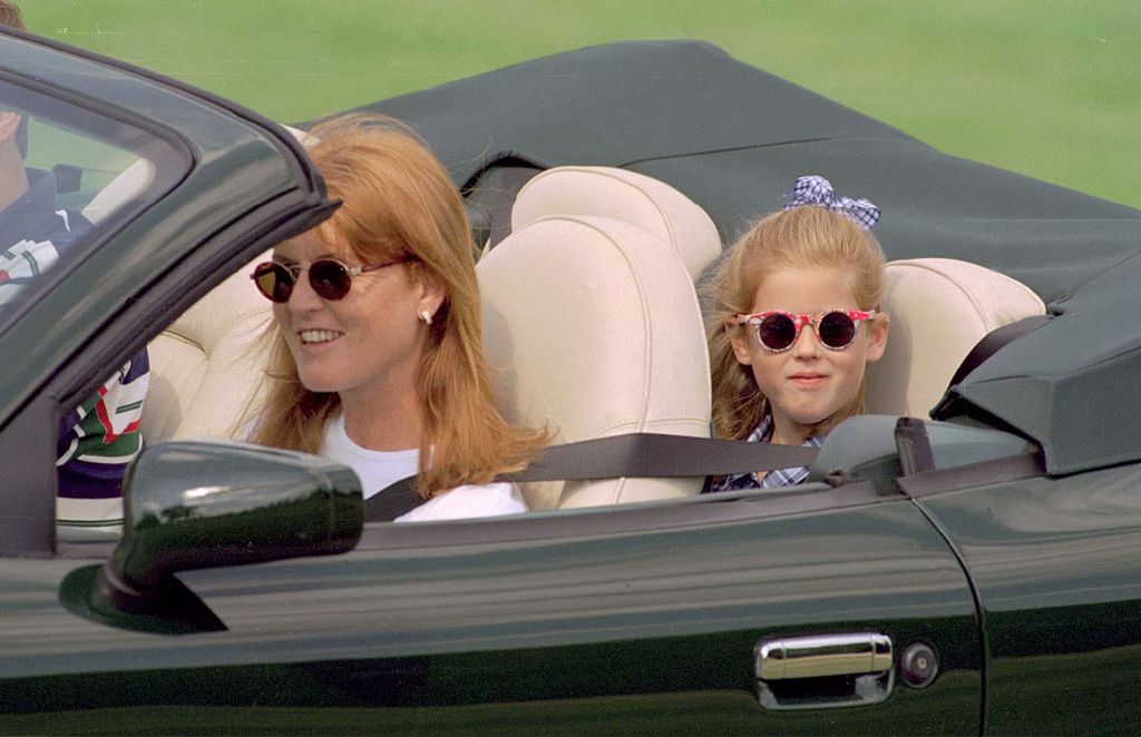 Princess Beatrice in the back of an open-top car with mum Sarah driving