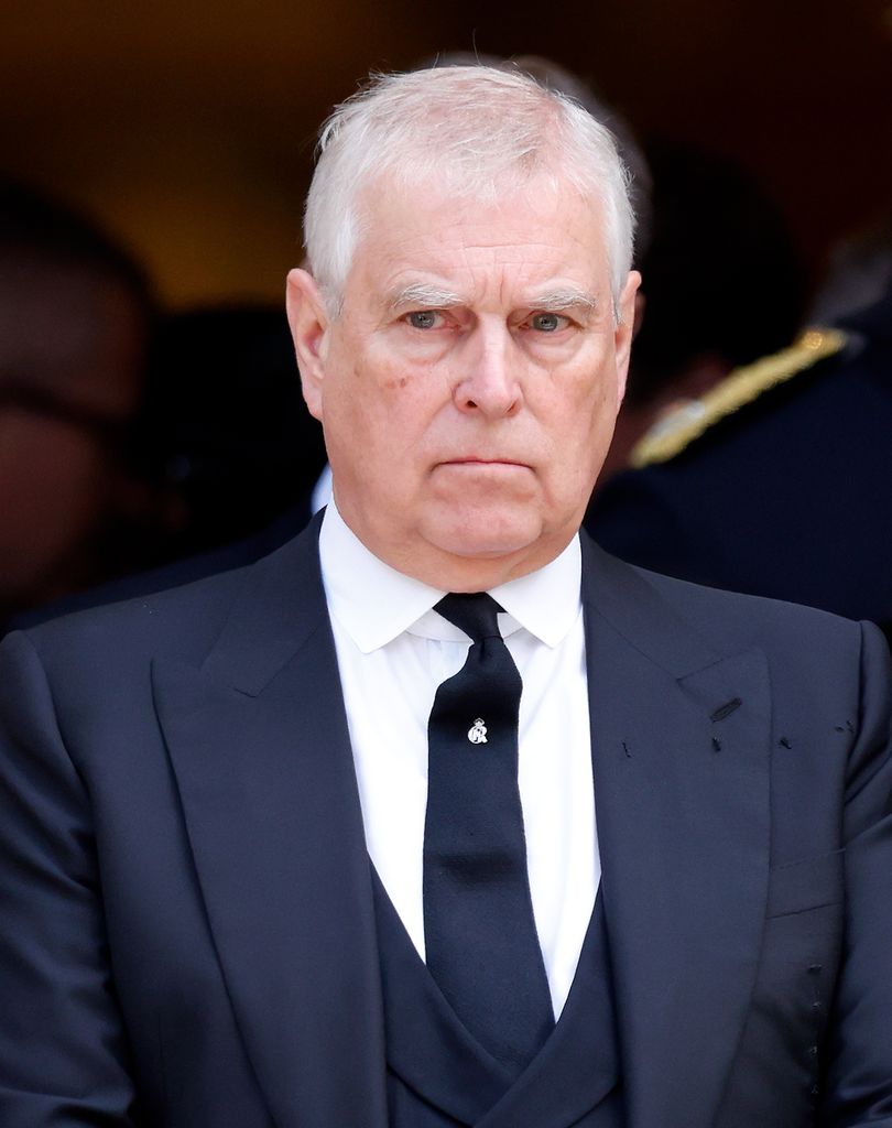 Prince Andrew frowning in a suit