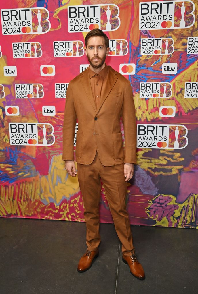 Calvin Harris in a brown suit