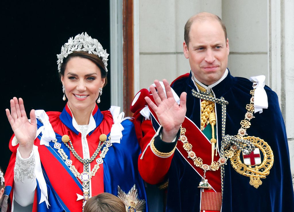 Princess Kate and Prince William in their coronation outfits waving from Buckingham Palace's balcony