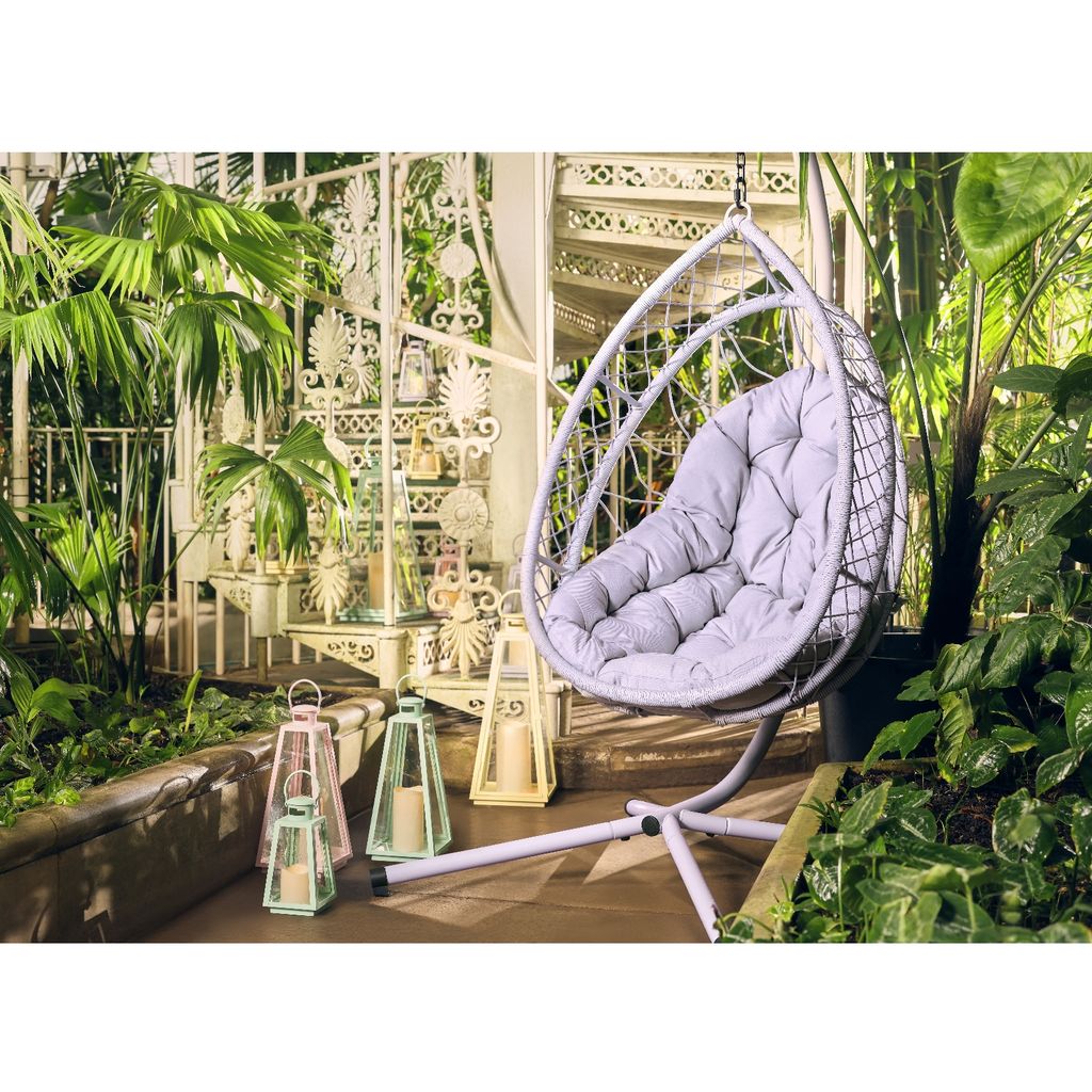 A lilac egg chair in a boho garden
