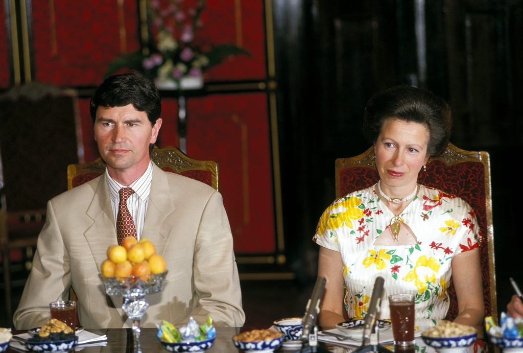 Princess Anne and Timothy Laurence sitting at a dinner table 
