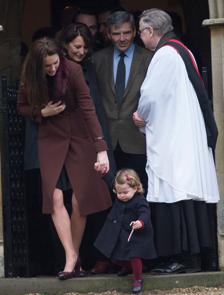 Kate Middleton holding Princess Charlotte's hand as Carole and Michael Middleton look on