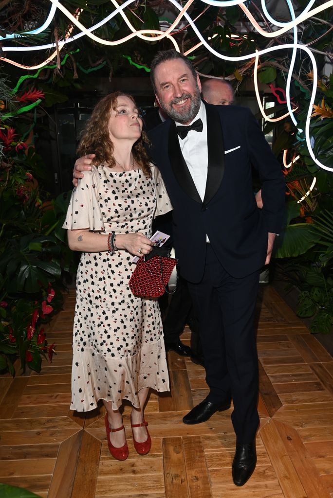 Tara McKillop in spotted dress standing with Lee Mack in a tuxedo