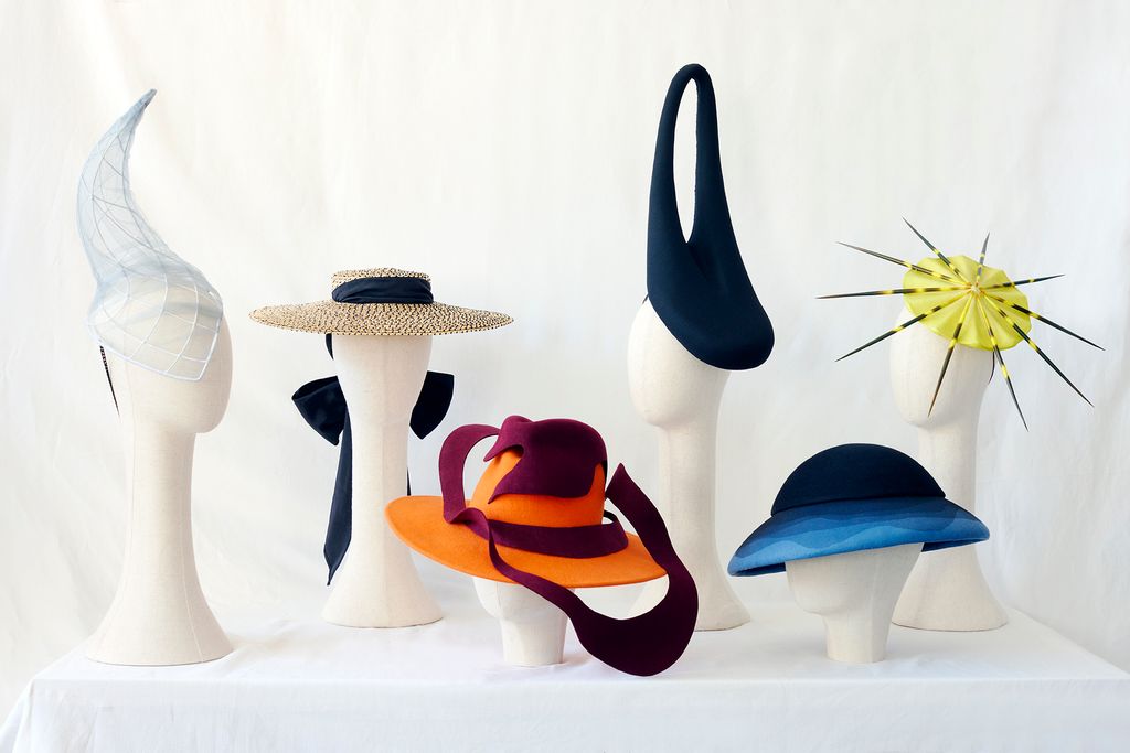 A striking lineup of six avant-garde hats on mannequin heads, featuring sculptural silhouettes in mesh, felt, and straw, designed by fellows of The King’s Foundation and CHANEL millinery programme.