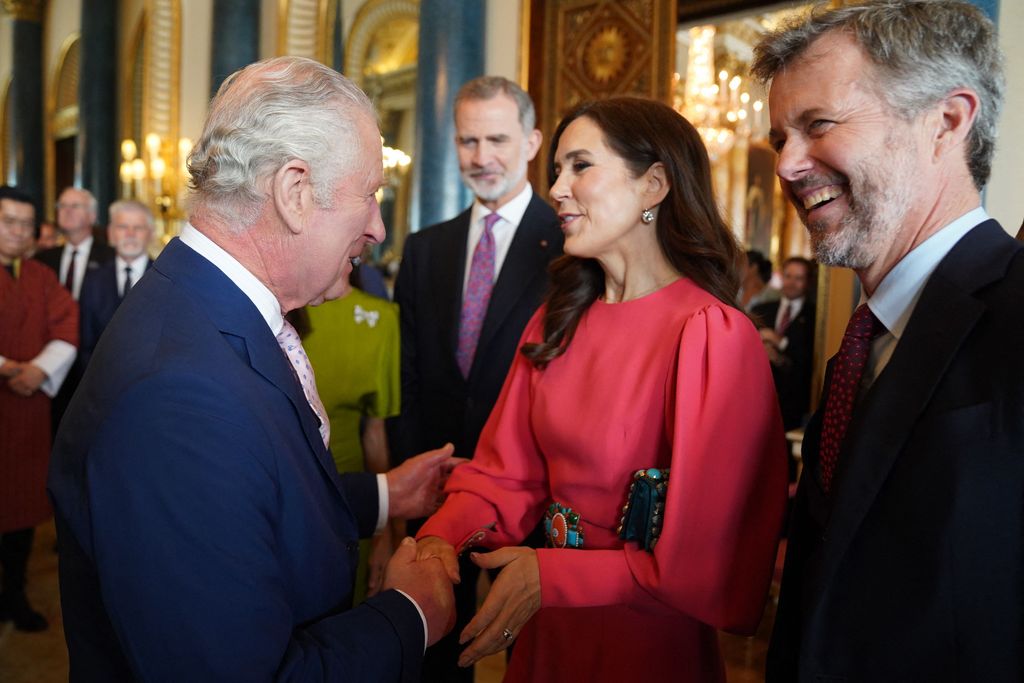 The King speaks with Crown Princess Mary of Denmark and Crown Prince Frederik of Denmark