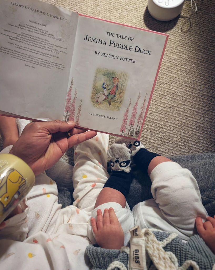 Will Kirk reading bedtime story to newborn baby son