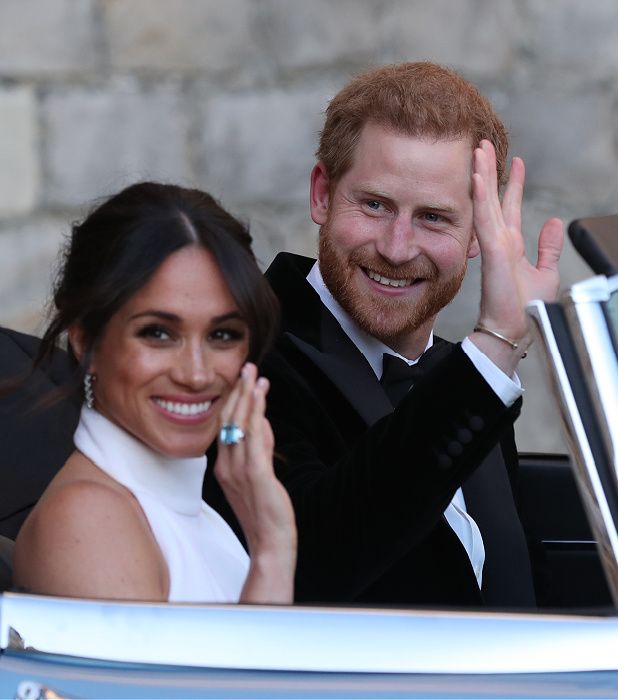 Meghan Markle and Prince Harry wave after their wedding reception