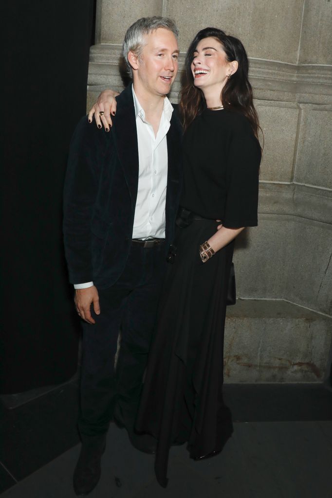 Adam Shulman in navy suit and Anne Hathaway in black skirt at the 2025 God's Love We Deliver Golden Heart Award