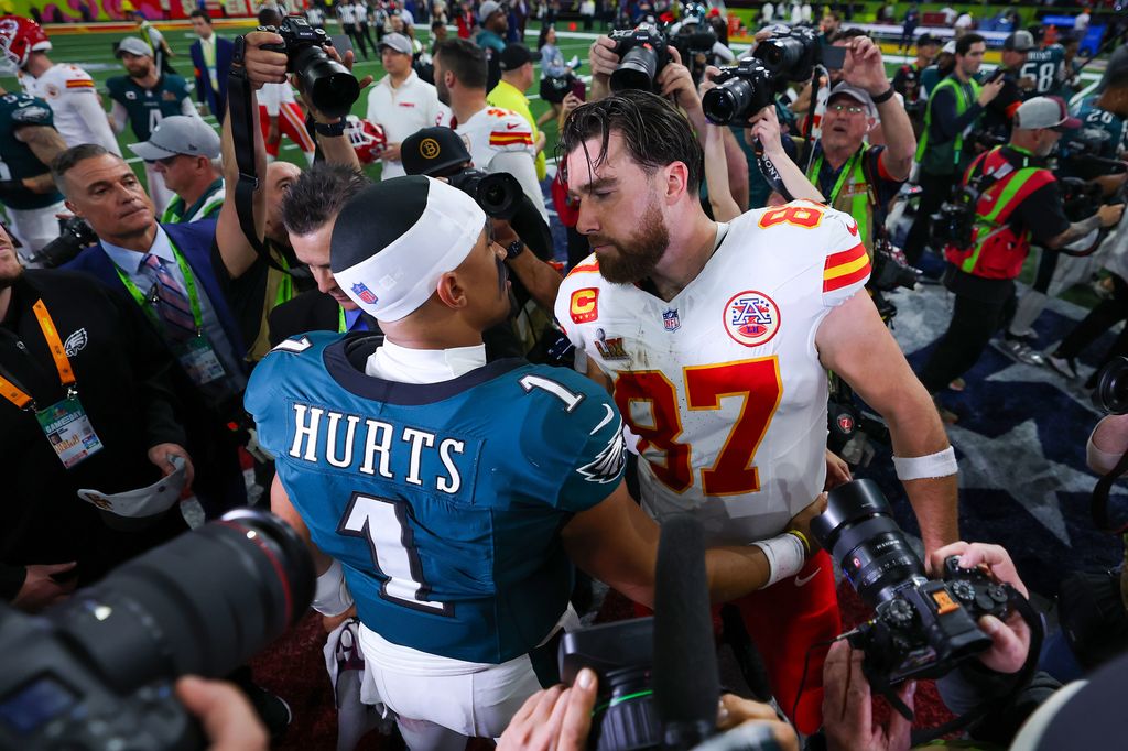 Jalen Hurts #1 of the Philadelphia Eagles and Travis Kelce #87 of the Kansas City Chiefs meet after Philadelphia beat Kansas City 40-22 to win Super Bowl LIX at Caesars Superdome on February 09, 2025 in New Orleans, Louisiana