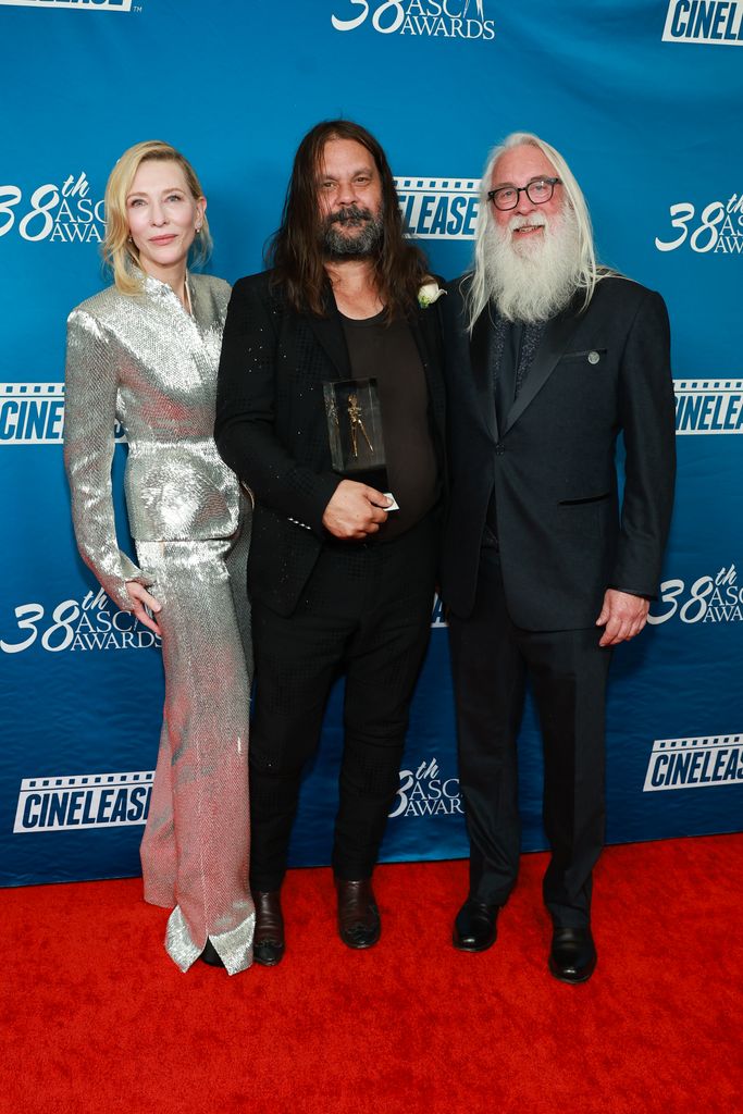 Cate in silver pant suit with Warwick Thornton, and Rodney Taylor 