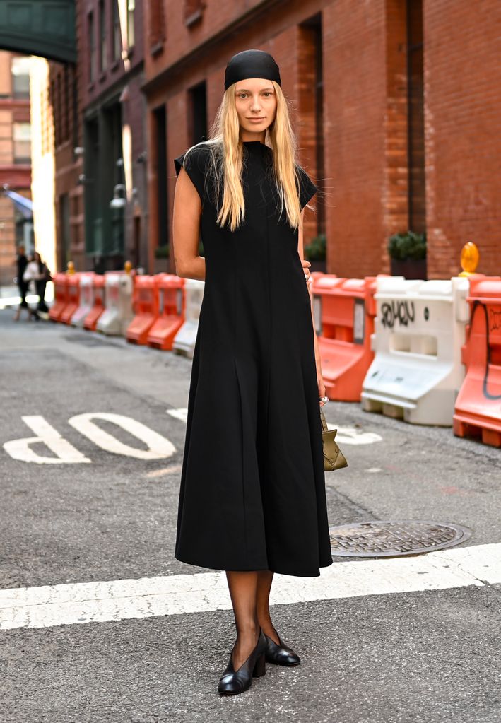 Maya Stepper is seen wearing a black Proenza Schouler dress and black head piece with black shoes outside the Proenza Schouler show on September 04, 2024 in New York City