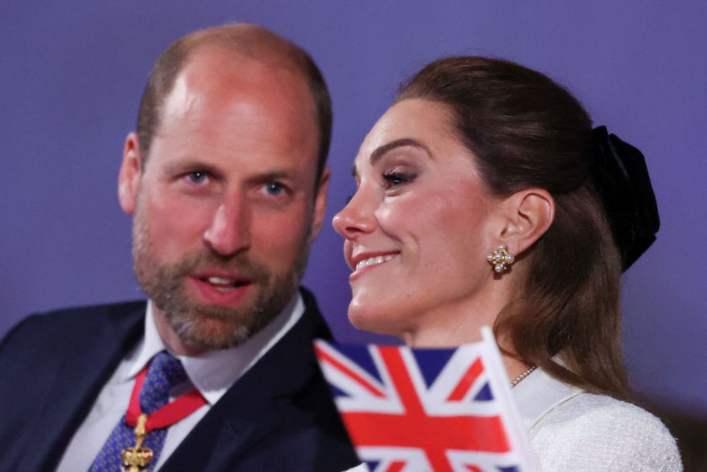 Kate smiling as William talks