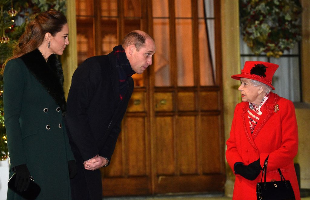 ueen Elizabeth II (R) talks with Prince William, Duke of Cambridge, (2L) and Catherine, Duchess of Cambridge, as they wait to thank local volunteers and key workers for the work they are doing during the coronavirus pandemic