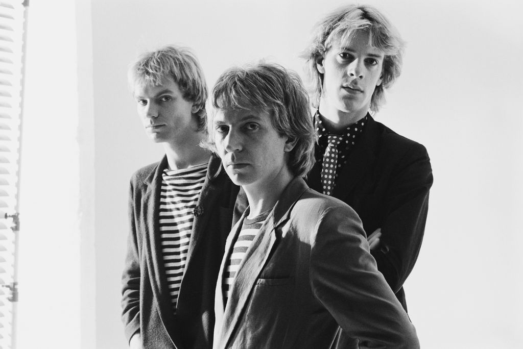 The Police (bassist and singer Sting, guitarist Andy Summers, and drummer Stewart Copeland), British rock band, pose for a group studio portrait, against a white background, United Kingdom, circa 1979. (Photo by Fin Costello/Redferns/Getty Images)