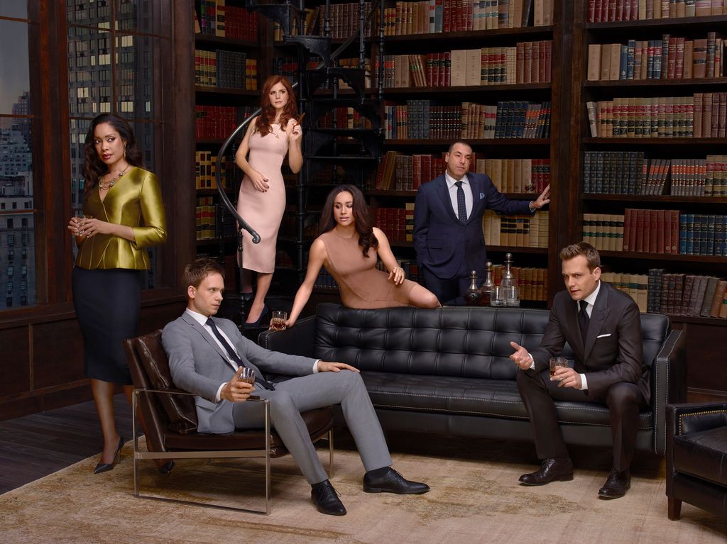 Promotional image of Suits featuring Gina Torres, Patrick J Adams, Sarah Rafferty, Meghan Markle, Rick Hoffman and Gabriel Macht
