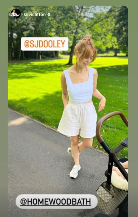 Stacey Dooley standing alongside Minnie's pushchair on a walk