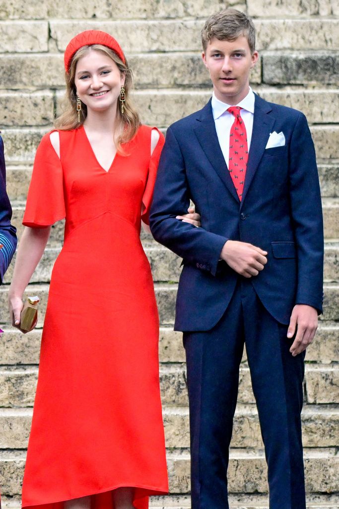 Princess Elisabeth in a red cut-out dress with Prince Emmanuel