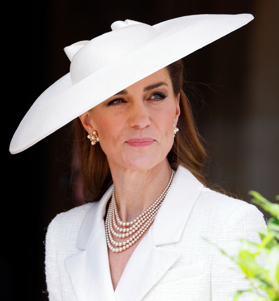 Kate Middleton in white with a blank expression
