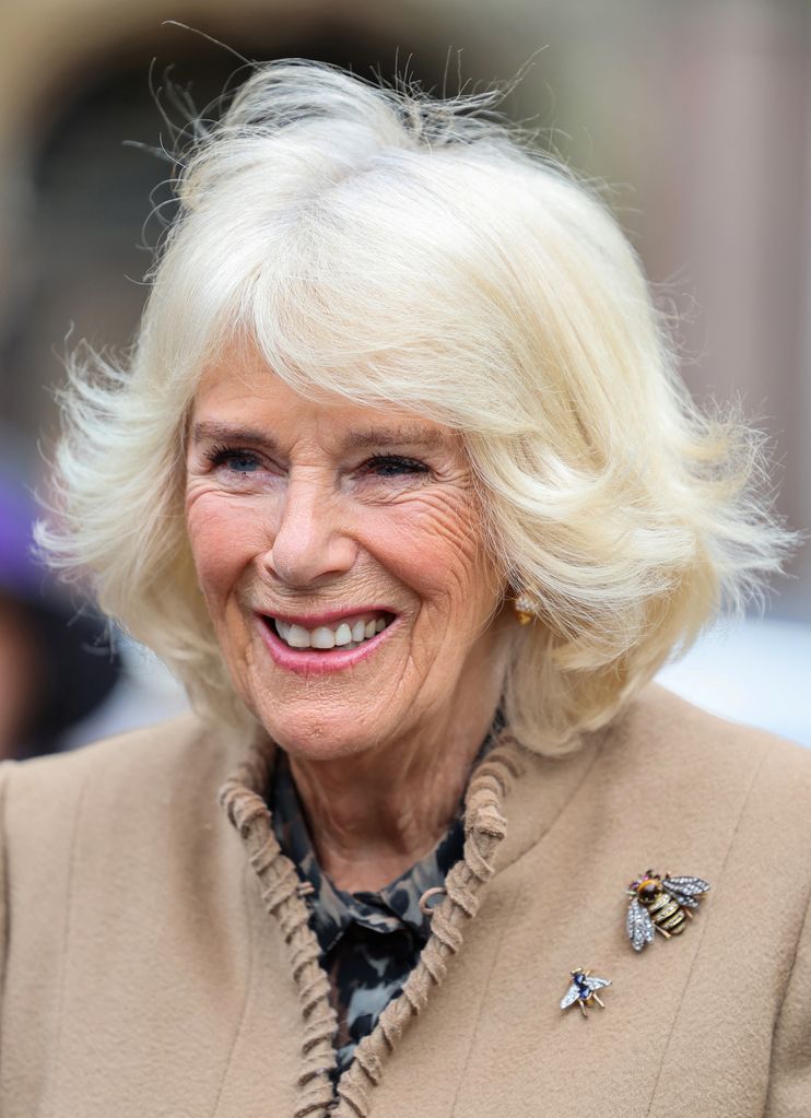 Queen Camilla wore a bejewelled bee brooch from her personal collection and a smaller brooch, believed to be Queen Elizabeth II's