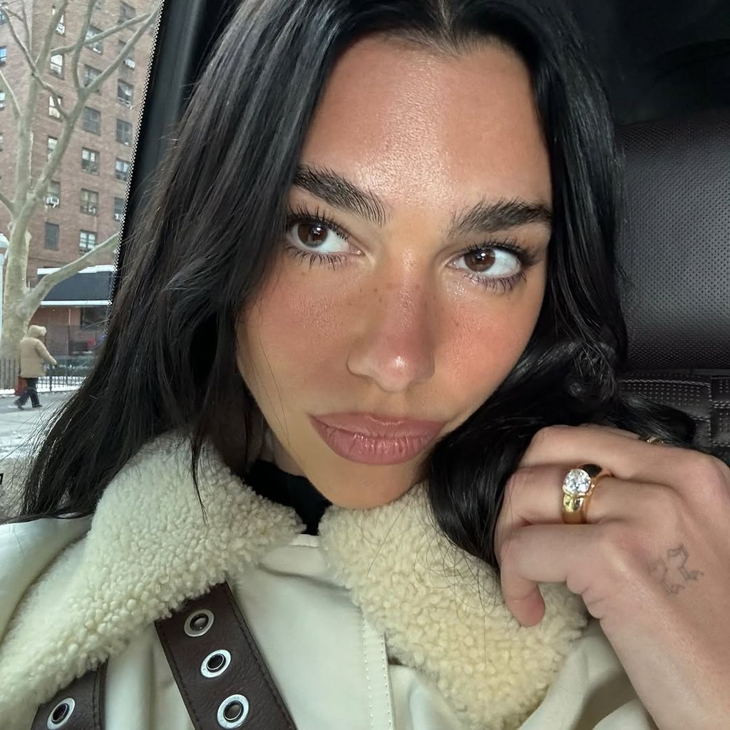 Dua Lipa pairs shearling bomber with her boho-chic engagement ring