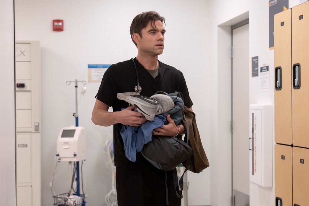 Dr Langdon (Patrick Ball) holds his items after being busted for stealing pills in a scene from The Pitt