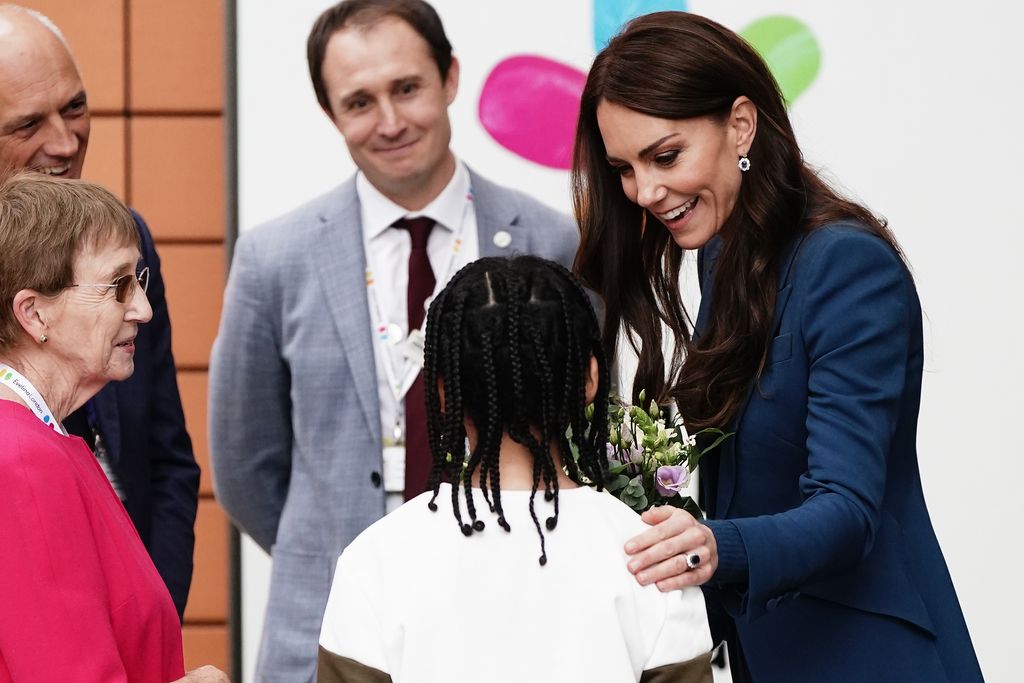 woman receiving flowers from child 