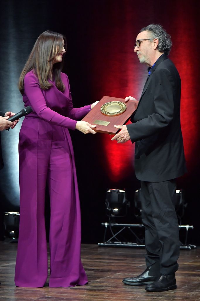 Tim Burton receives the Lumiere Award from the hands of Monica Bellucci during the award ceremony of the 14th Film Festival Lumiere on October 21, 2022 in Lyon, France.