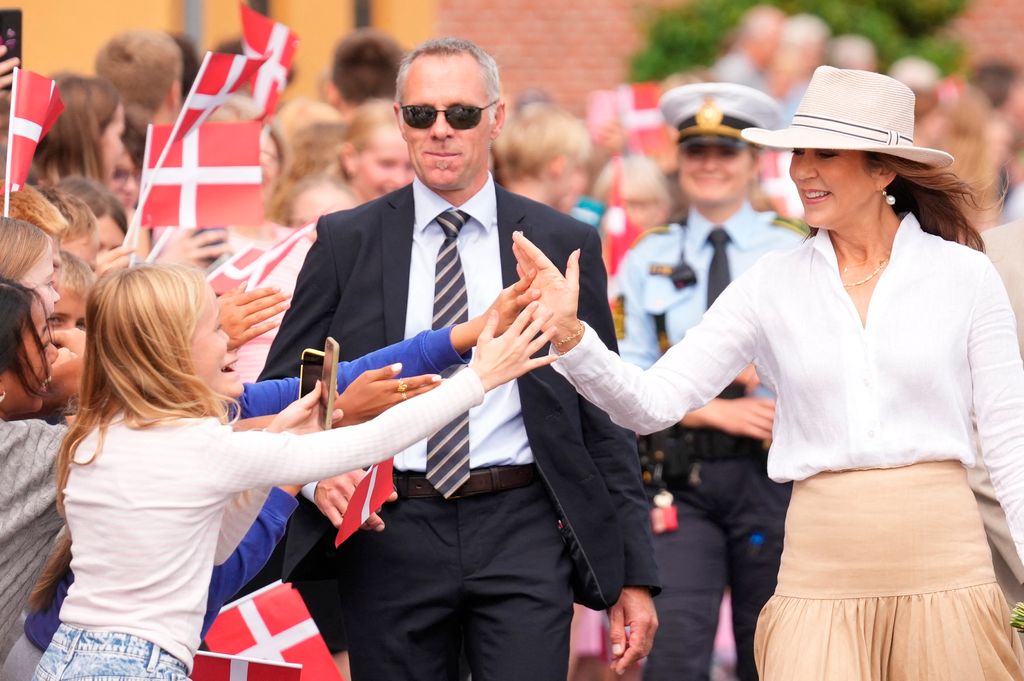 Queen Mary high-fives young well-wisher