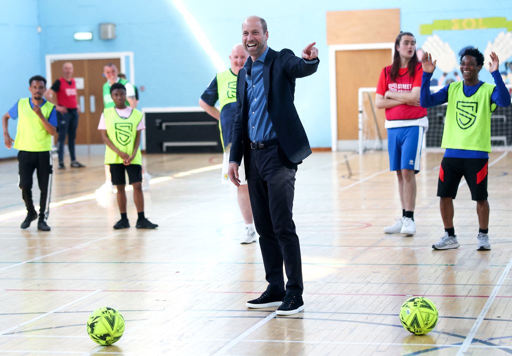 The Prince of Wales plays football during a visit as The Royal Foundation launches a new community impact partnership with Street Soccer Scotland