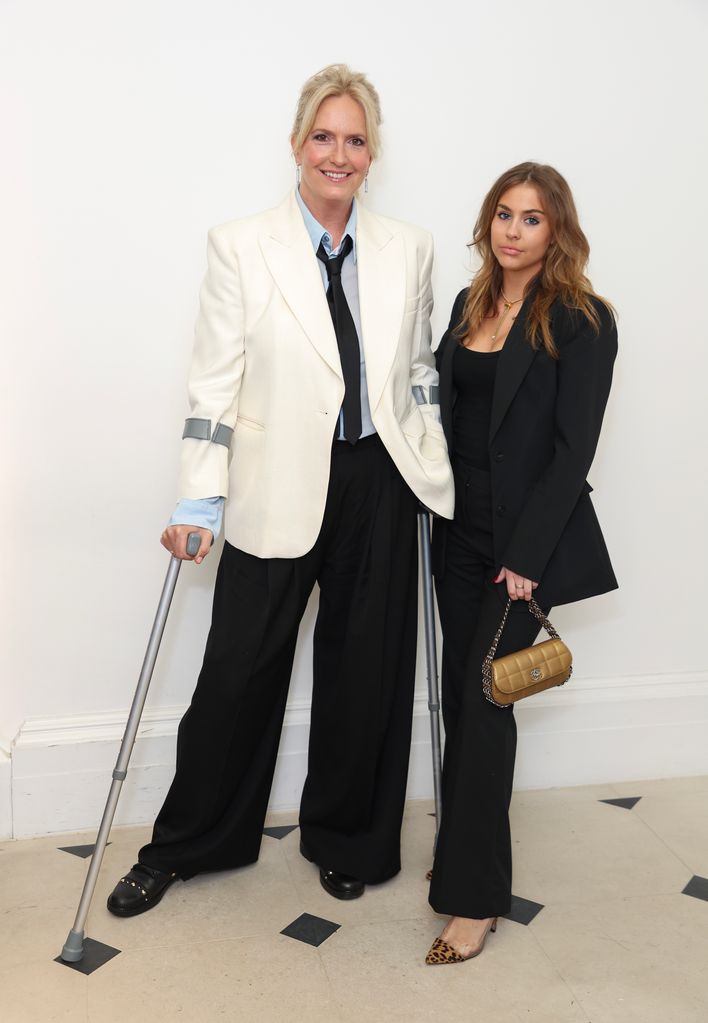 Penny Lancaster, 52, continues to use crutches as she joins