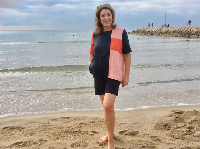 Jane McDonald stood on the beach