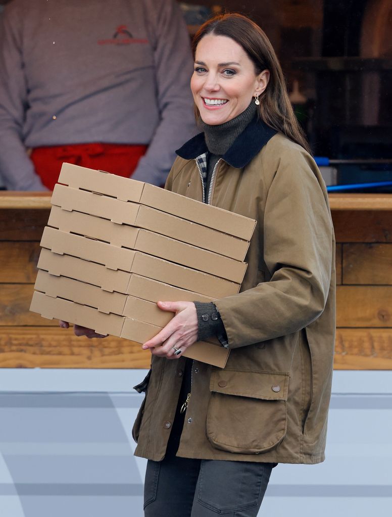 kate middleton in barbour coat holding pizza boxes 