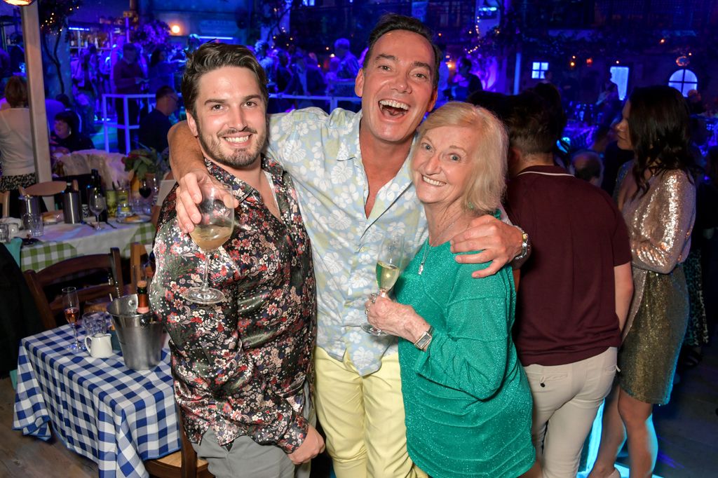 Craig Revel Horwood with his arms around Jonathan Myring and Beverley Horwood