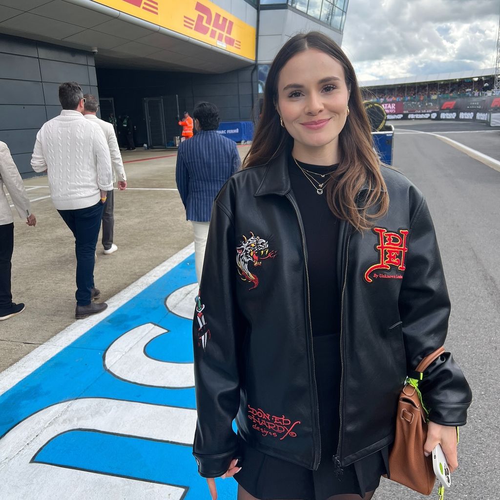 lady wearing black outfit at motor car circuit