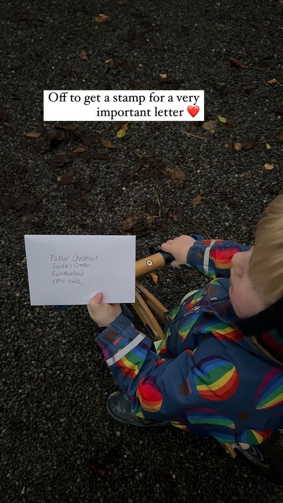 Small boy holding a letter for Santa