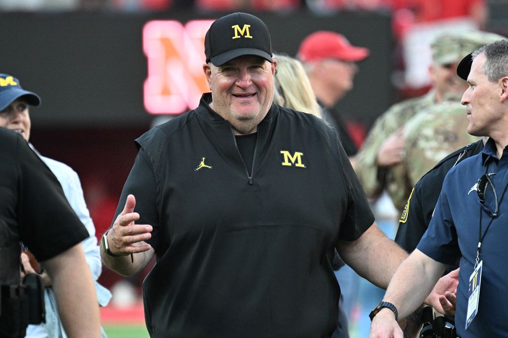 Acting head coach Biff Poggi of the Michigan Wolverines walks off the field after the win against the Nebraska Cornhuskers at Memorial Stadium on September 20, 2025 in Lincoln, Nebraska