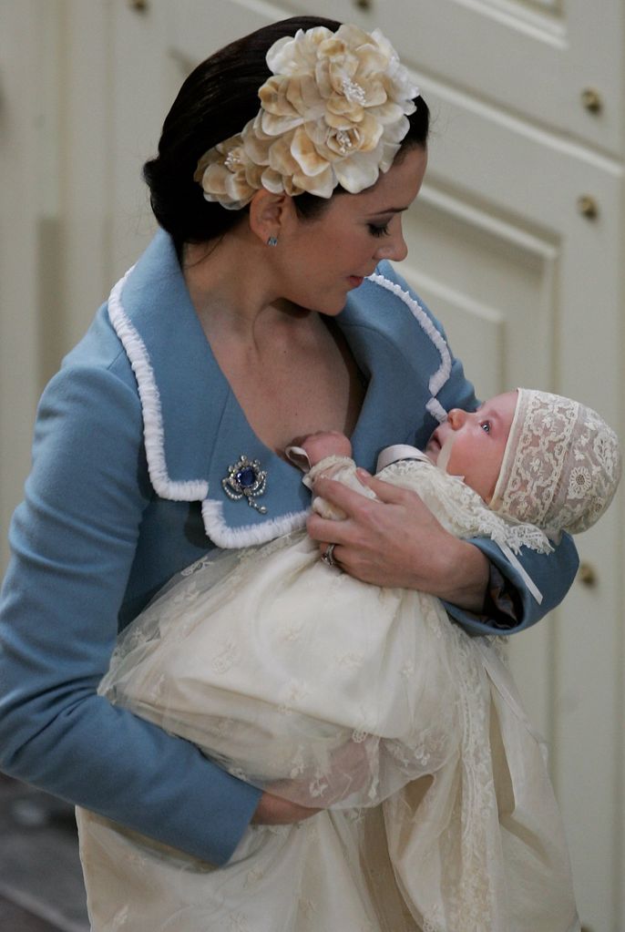 Crown Princess Mary of Denmark cradles her son Prince Christian as they arrive for the Royal Christening ceremony 