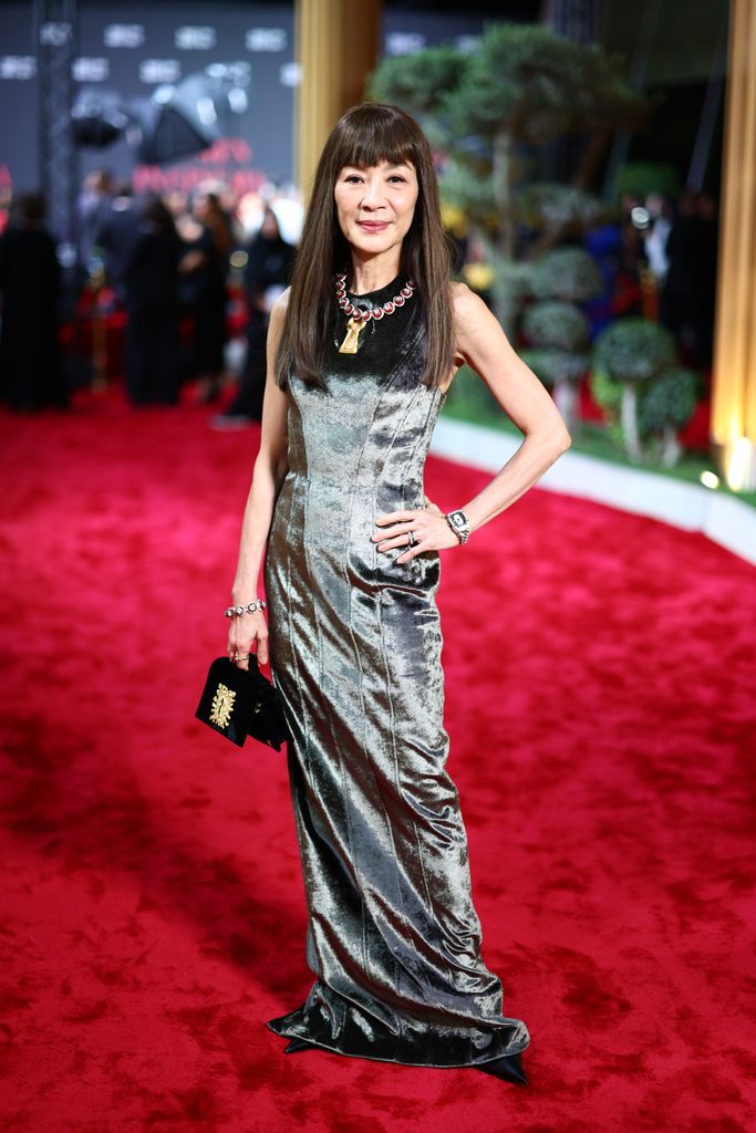 Michelle Yeoh on red carpet in velvet green dress