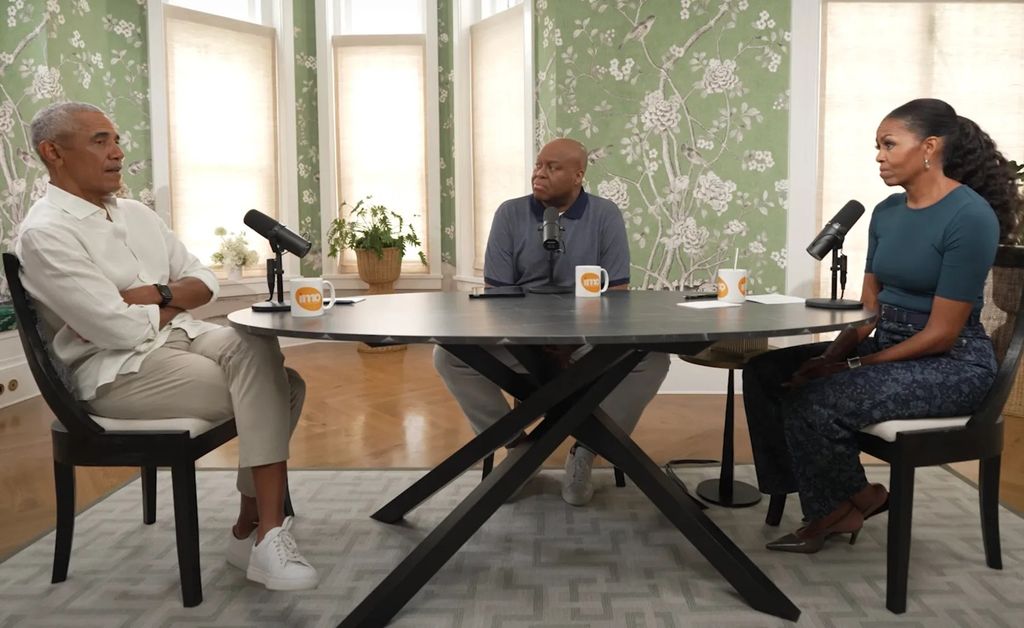 barack obama craig robinson and michelle obama sitting at a round table
