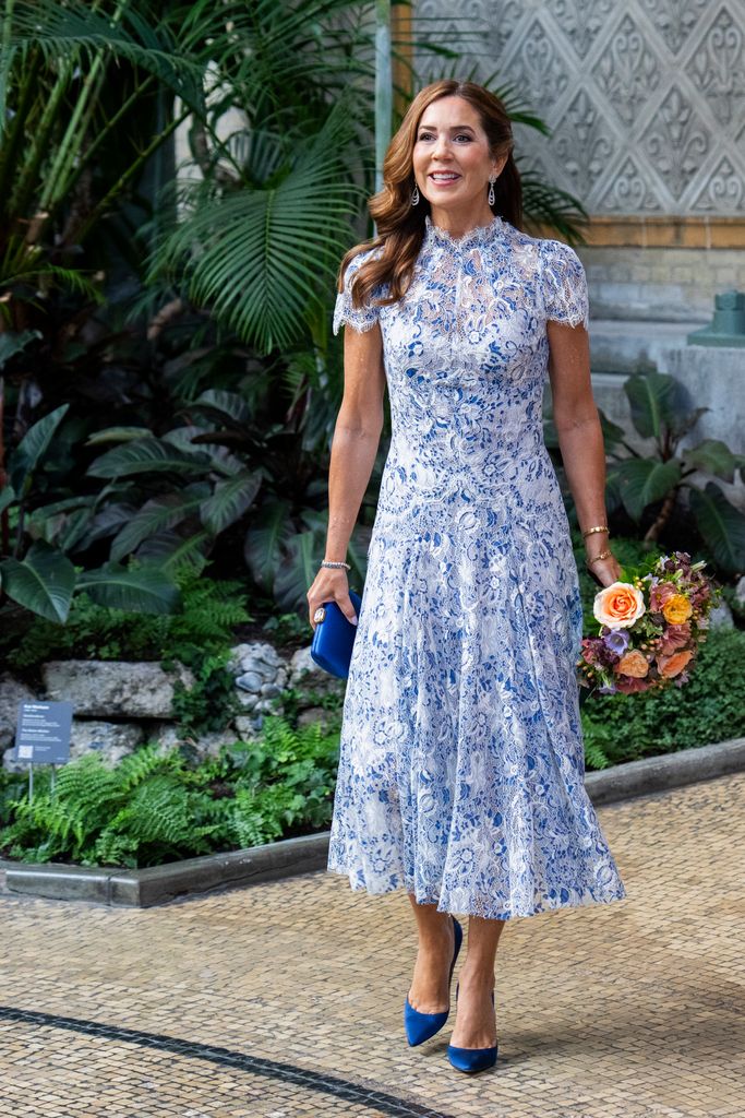 Mary in a blue lace dress with matching heels