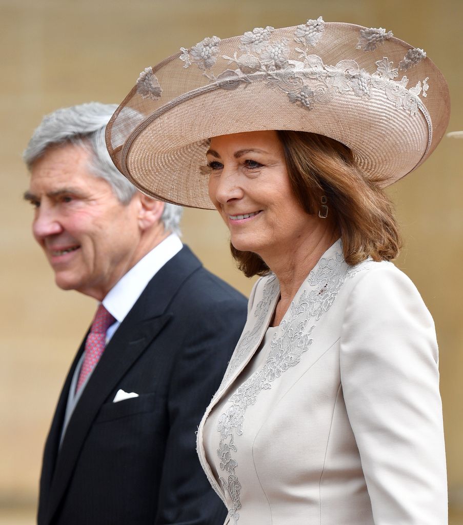Michael Middleton in a suit and Carole Middleton in a white jacket and cream hat