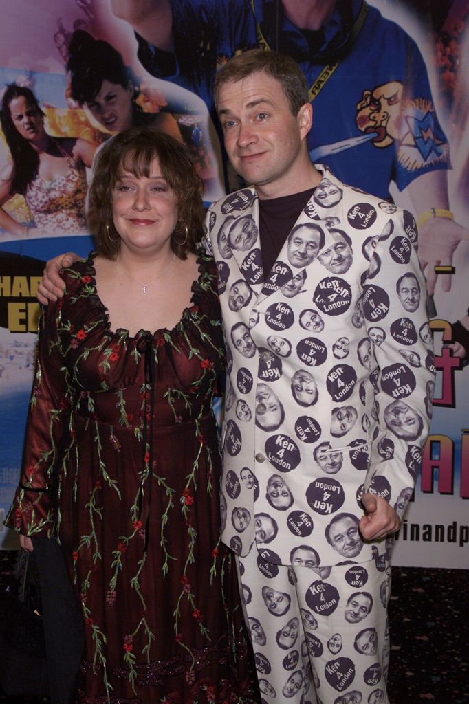 Kathy Burke in printed black dress beside harry enfield