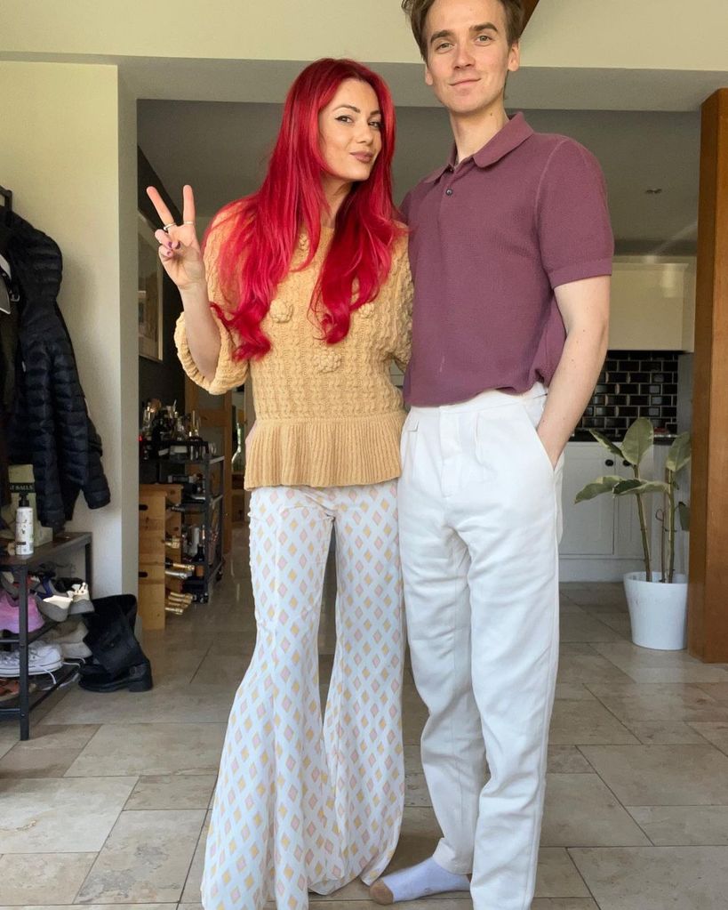 dianne buswell with long red hair posing with joe sugg