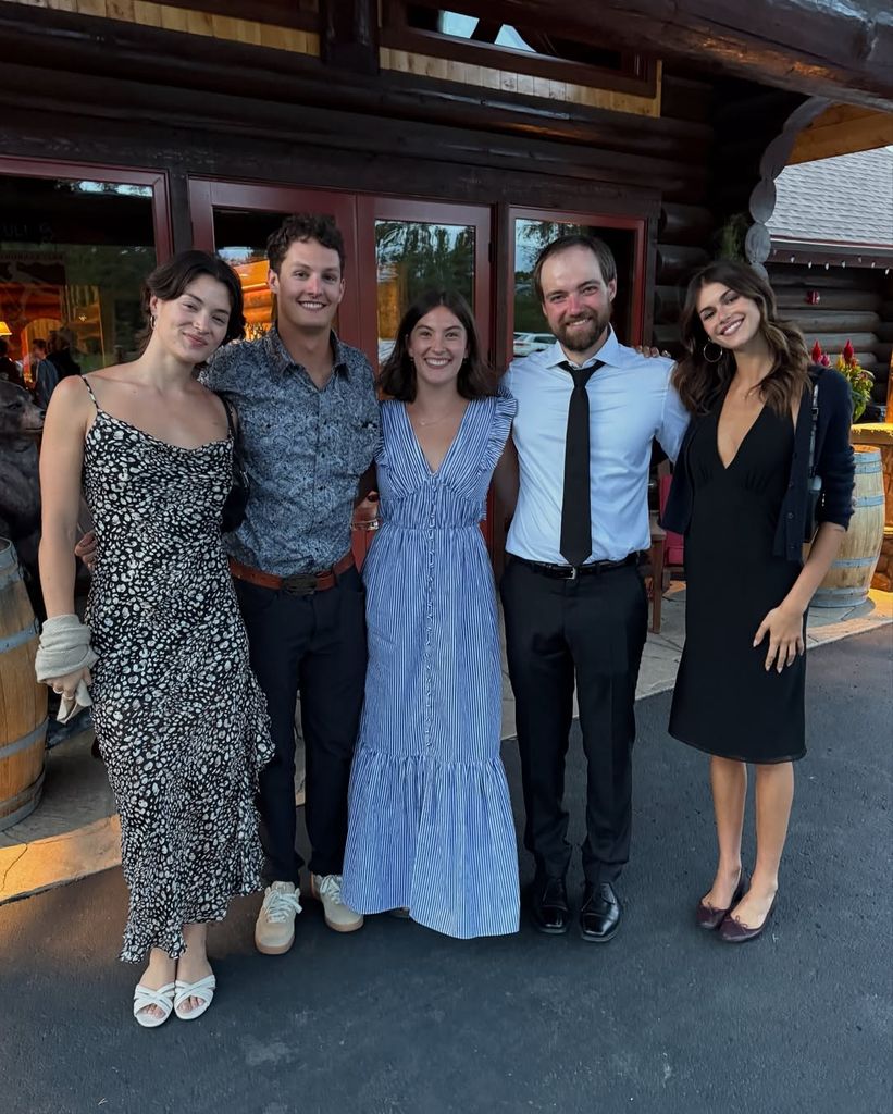 Model Kaia Gerber in black midi dress and ballet flats