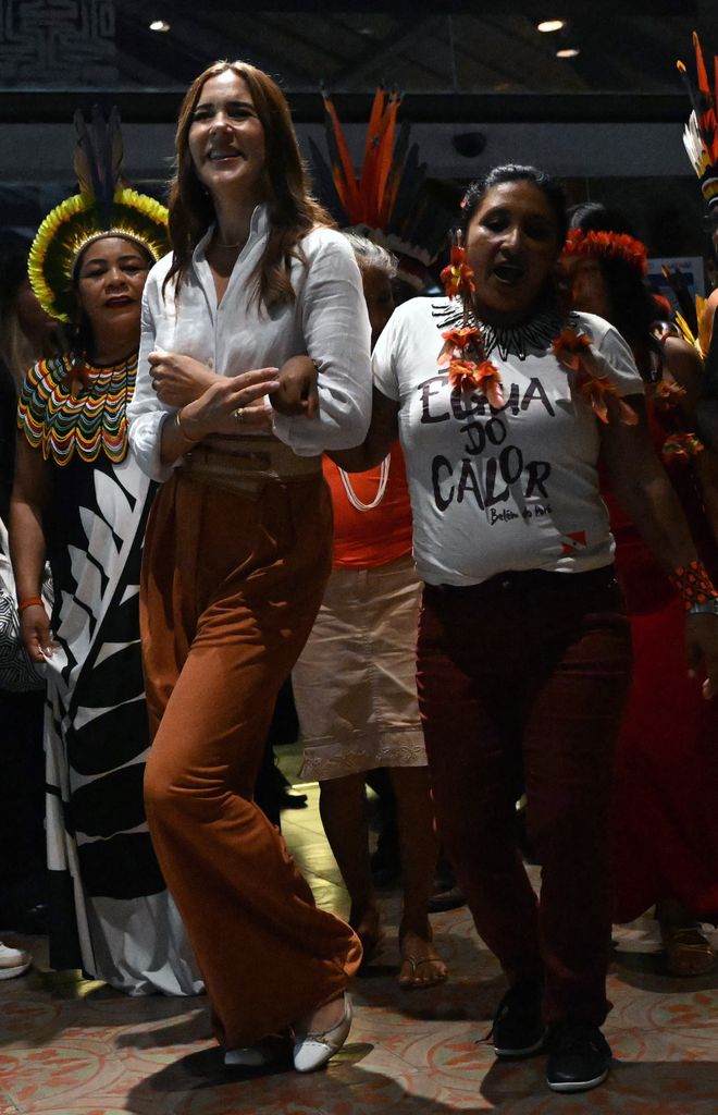 Queen Mary joins a ritual dance with Indigenous people at Utinga Park