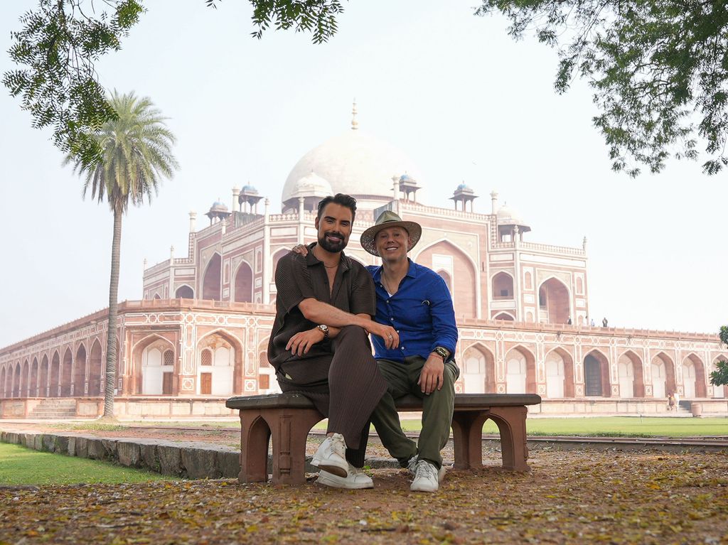 Two people sitting on a bench, outside Humayun's Tomb