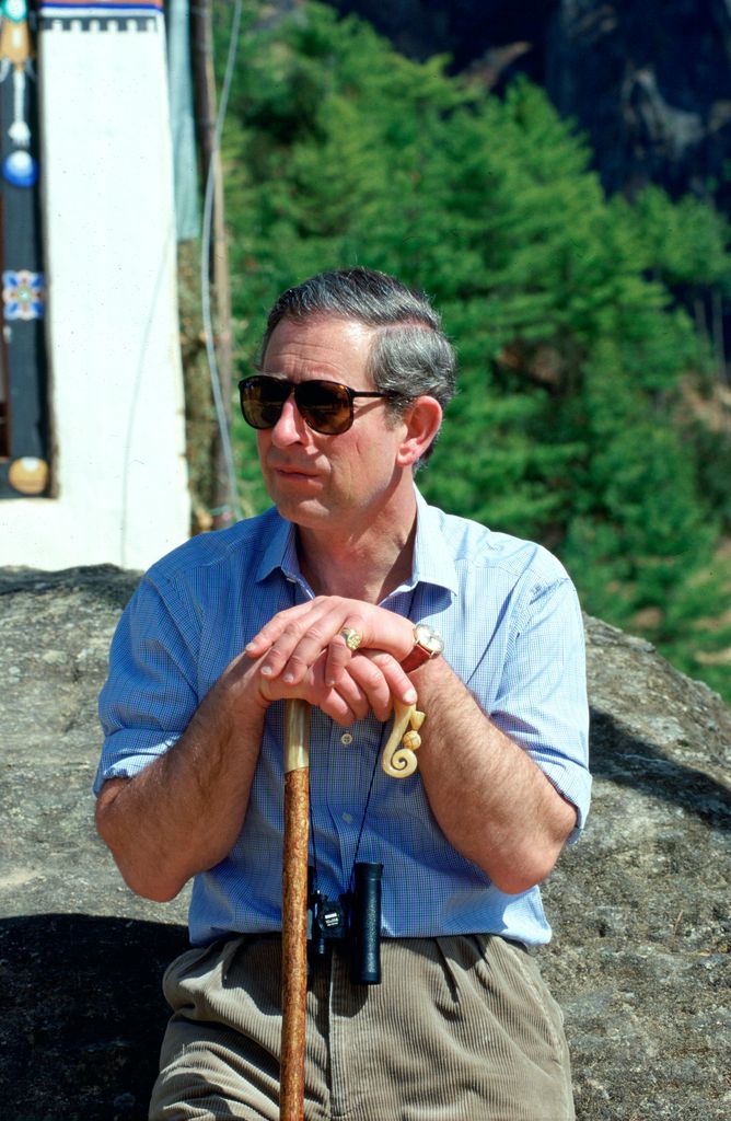 King Charles with a walking stick resting on the ornate handle